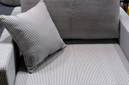 small sofa with a stylish pillow, variegated fabric in black and white tonesの写真素材