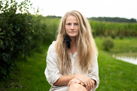 Portrait of young natural woman on green nature backgroundの写真素材