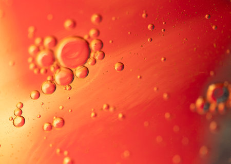 Oil in water, abstract background in yellow and red color tonesの写真素材