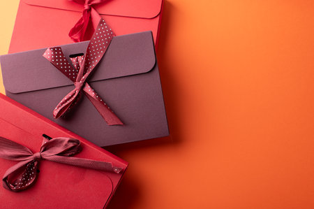 Red gift boxes on orange color backgroundの写真素材