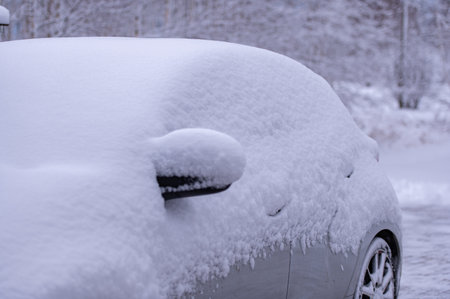 The side and mirror of the car in the snow after snowstormの写真素材