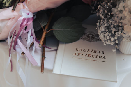 Rich wedding flower collection arranged on round ceremony table with white cloth.の写真素材
