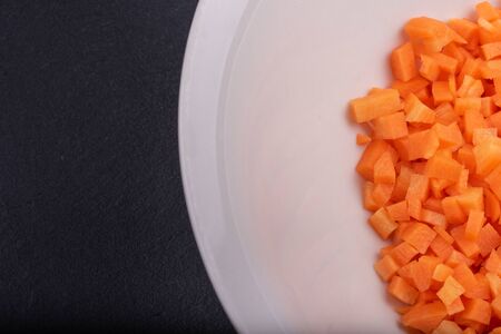 fresh carrots cut into cubes on a plate
