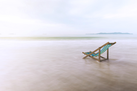 Long exposure of beach chairs on the white sand beach backgroundの写真素材