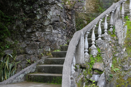 Old vintage staircase with steps and handrail made of concreteの写真素材