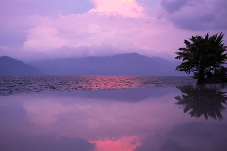 Sunset with reflections, Lake Toba, Indonesia.の写真素材