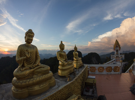 Statues of Buddha at Tiger Temple on the top of karst mount at sunset, Krabi Province, Thailandの写真素材