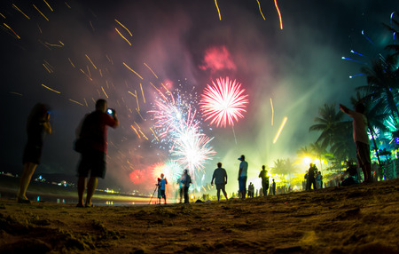 Colorful fireworks on the beach, New Year celebration in Phuket, Thailand. People on the front are de-focused, blurred and not recognizable.の写真素材