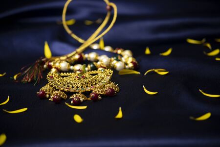 Golden Jaipuri Choker set isolated on silky dark blue backgroundの写真素材