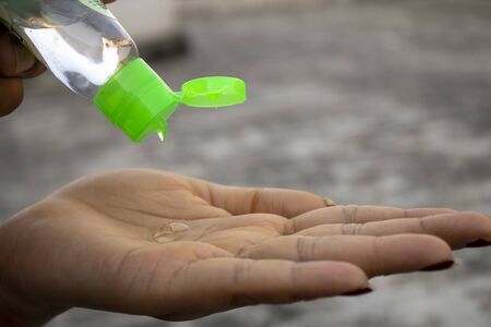 Women sanitizing hands with sanitizerの写真素材