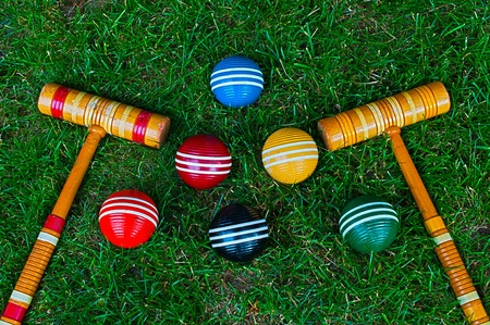 Croquet mallets and balls on grass backgroundの写真素材