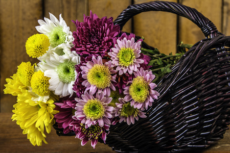 wicker basket of assorted spring flowersの写真素材