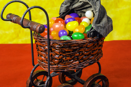 antique baby buggy full of jelly beansの写真素材