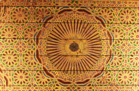 Golden eastern pattern on the ceiling of an old building in Marrakech, Moroccoの写真素材
