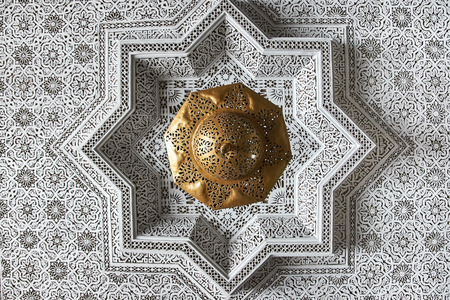 White and golg oriental ornament on the ceiling of a home in Moroccoの写真素材