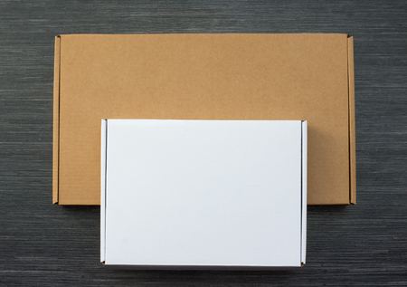 Brown and white carton boxes isolated on wooden background. Top viewの写真素材