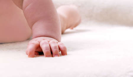 Little hand of a crawling baby close-up.