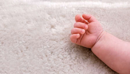 Little baby hand clenched into fist.の写真素材