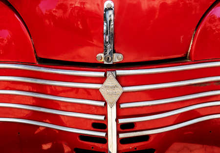 Grid grille in the hood with logo Renault close up on the Renault vintage car in Danang, Vietnam -...