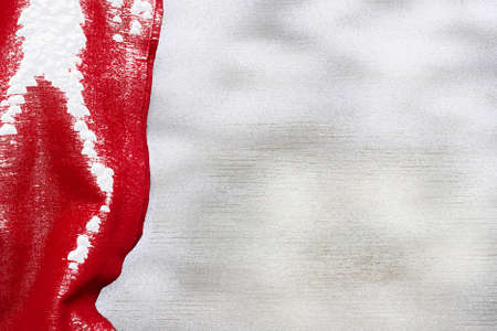 Festive Christmas holiday winter background with bright red tablecloth  covered sparkling snowflakes on rustic wooden table. Frost patternの写真素材