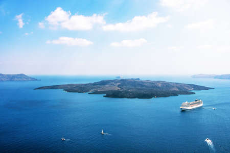 Aerial view of modern luxury tourist cruise ship in the bay of Santorini, Greeceの写真素材