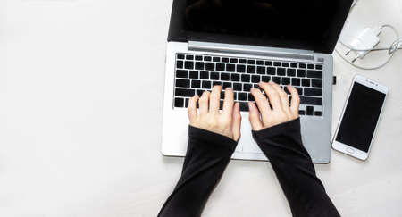 Woman working on a laptop in the workplace.