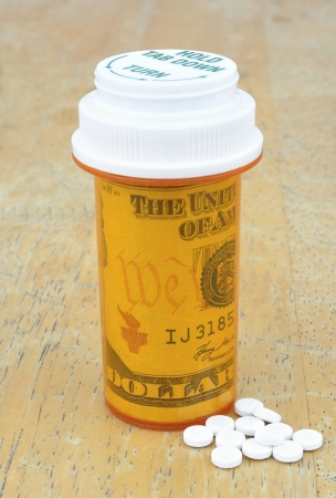 pill bottle with moneyの写真素材
