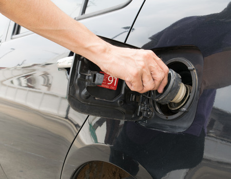 Hand opening the oil filler cap
