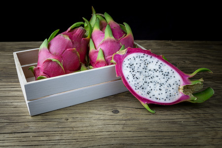 Dragon Fruit On old Wooden Table, Selective focus.の写真素材