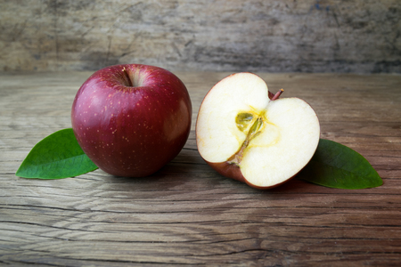Red apples on a wooden tableの写真素材