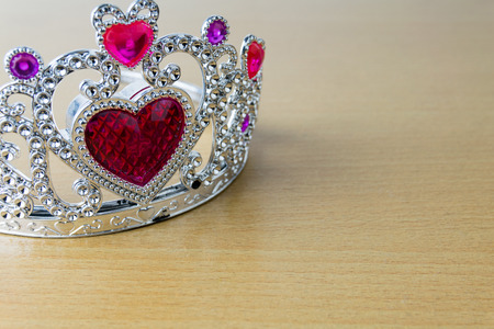 crown red hearts on wooden tableの写真素材