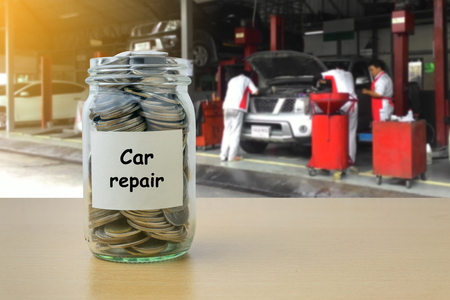 Money saving for Car repair in the glass bottleの写真素材
