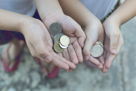 Coin in children hand. Business and finance conceptの写真素材