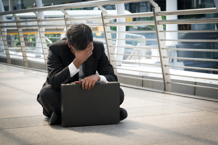 Businessman is disappointed from losing in stock exchange, economic crisis conceptの写真素材