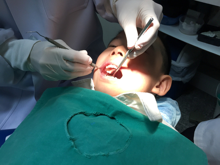 Kid having mouth checkup in dental clinicの写真素材