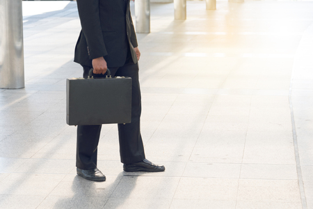 
Businessman pulling a bag in a big city.の写真素材