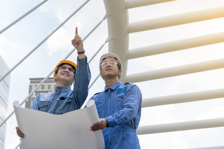 Engineer and Architect working at Construction Site with blueprintの写真素材