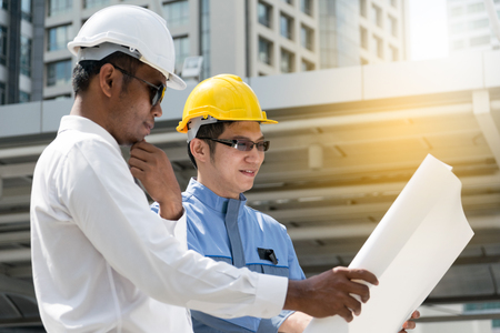 Engineer and Architect working at Construction Site with blueprintの写真素材