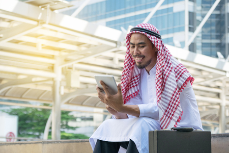 Arab businessman using tablet  in the cityの写真素材