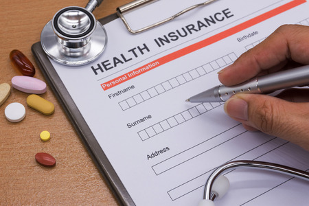Health insurance paperwork, medicine, stethoscope. Health insurance claim concept.