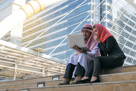 Arab Businessman and Businesswoman using computer, finance conceptの写真素材