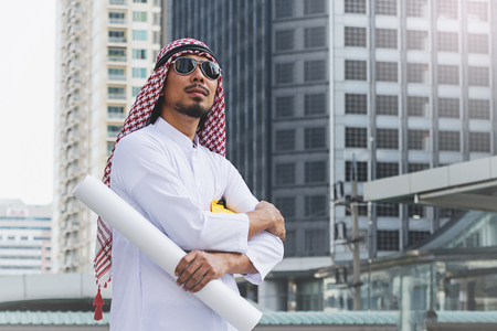 Arab Engineer construction worker holding blueprintの写真素材