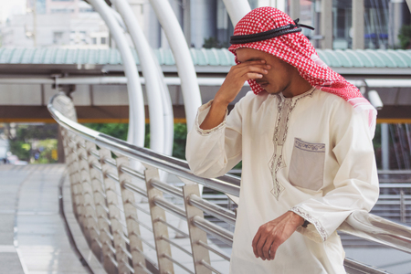 Arab Businessman is disappointed from losing in stock exchange, economic crisis conceptの写真素材
