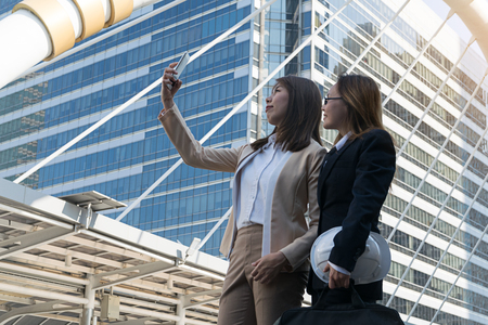 Happy businesswomen making selfie photo at cityの写真素材
