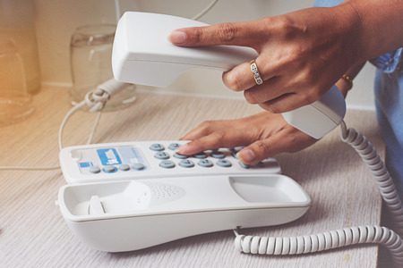 Hand of woman using telephone