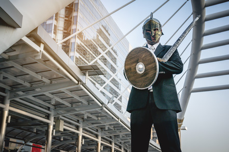 Knight businessman wearing an helm and steel sword.の写真素材