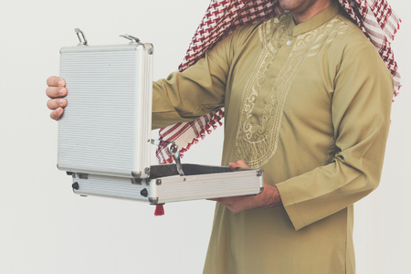 Arab businessman opening suitcaseの写真素材