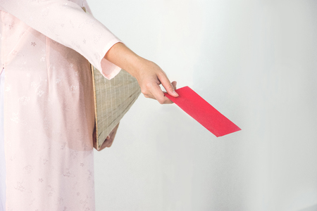 Vietnam woman holding red envelope, woman wear Vietnamese, Vietnamese new yearの写真素材