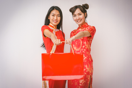 Chinese women friends enjoying shopping, woman wear cheongsamの写真素材