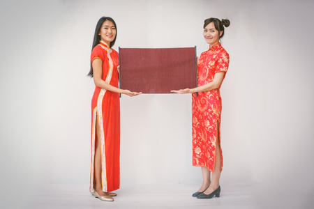 Two women couple holding banner with Chinese new year.の写真素材